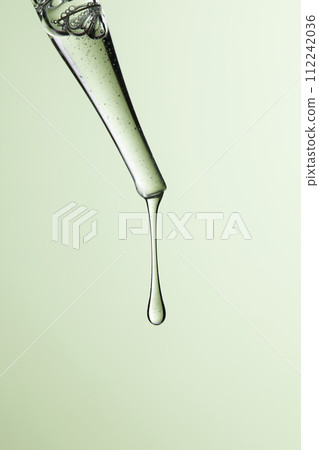 Clear liquid droplets falling from a dropper that can be used for cosmetic and medical images. 112242036
