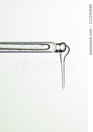 Clear liquid droplets falling from a dropper that can be used for cosmetic and medical images. 112242080