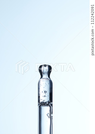 Clear liquid droplets falling from a dropper that can be used for cosmetic and medical images. 112242091