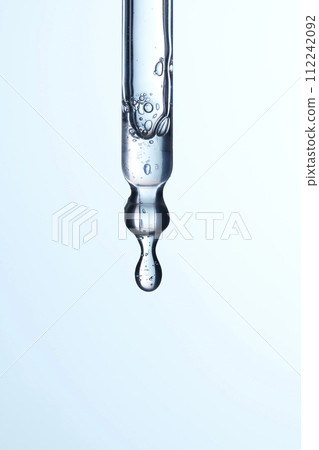 Clear liquid droplets falling from a dropper that can be used for cosmetic and medical images. 112242092