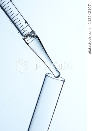Clear liquid droplets falling from a dropper that can be used for cosmetic and medical images. 112242107