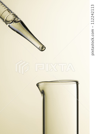 Clear liquid droplets falling from a dropper that can be used for cosmetic and medical images. Clear liquid droplets falling from a dropper that can be used for cosmetic and medical images. 112242113