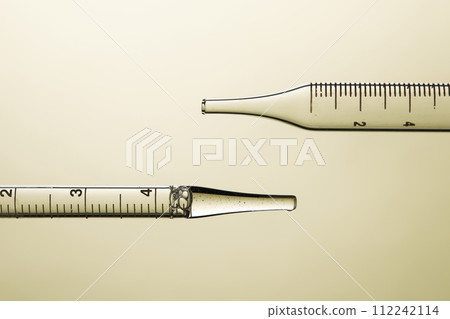 Clear liquid droplets falling from a dropper that can be used for cosmetic and medical images. 112242114