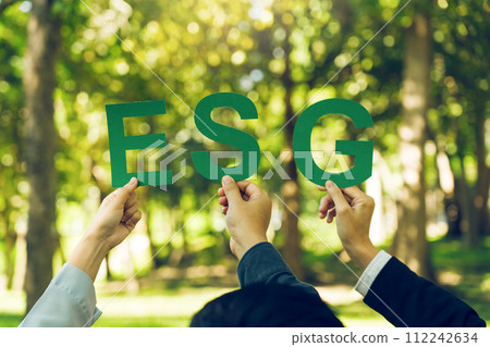 Hands of business team holding ESG text, Environmental, social and corporate governance concept. Hands of business team holding ESG text, Environmental, social and corporate governance concept. 112242634