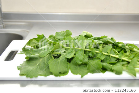 radish leaves on a cutting board 112243160