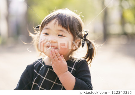 little girl smiling in the park little girl smiling in the park 112243355
