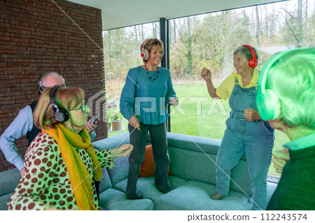 Seniors Enjoying a Vibrant Silent Disco Party 112243574