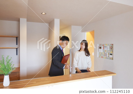 A man and a woman giving real estate information A man and a woman giving real estate information 112245110