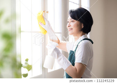 Housekeeping service Woman cleaning windows Housekeeping service Woman cleaning windows 112245229
