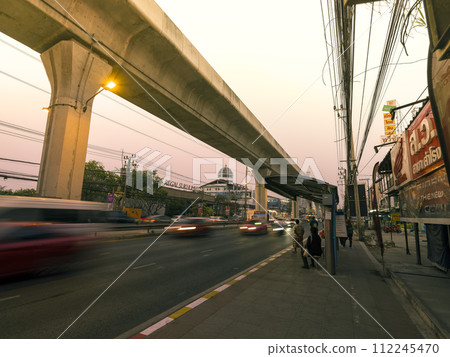 Main road at dusk on the outskirts of Bangkok, Thailand / Sukhumvit Road, Thailand Main road at dusk on the outskirts of Bangkok, Thailand / Sukhumvit Road, Thailand 112245470