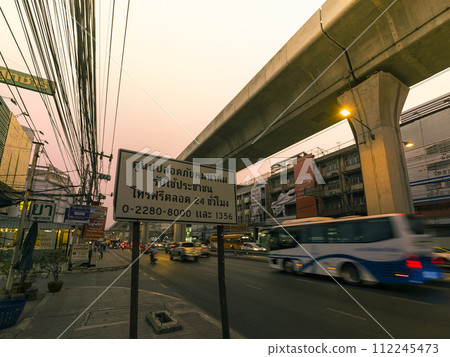 Main road at dusk on the outskirts of Bangkok, Thailand / Sukhumvit Road, Thailand Main road at dusk on the outskirts of Bangkok, Thailand / Sukhumvit Road, Thailand 112245473