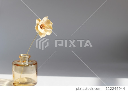 A single colored dried flower in a small brown vase A single colored dried flower in a small brown vase 112246944