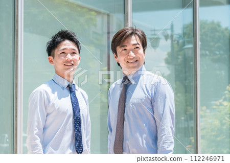 Male businessman in front of an office building (boss, subordinate, team, senior, junior) Male businessman in front of an office building (boss, subordinate, team, senior, junior) 112246971
