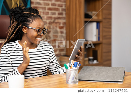 Happy Afro American Woman Enjoying Video Call at Home Office Happy Afro American Woman Enjoying Video Call at Home Office 112247461