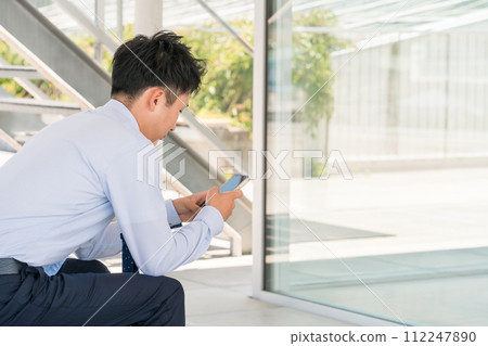 Male businessman using smartphone (rest, meeting, fatigue) 112247890