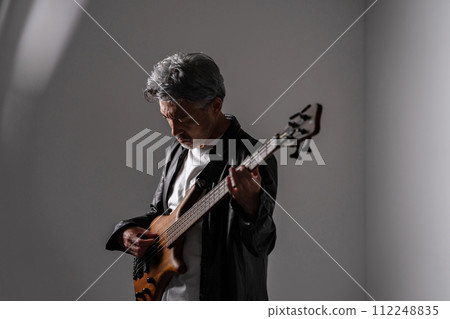 Senior man playing guitar Senior man playing guitar 112248835