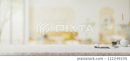 A presentation space for display product on a white marble table in a contemporary coffee shop. A presentation space for display product on a white marble table in a contemporary coffee shop. 112249339