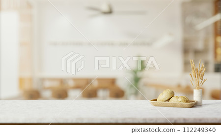 A white marble table features a copy space with a blurred background of a minimally cozy coffee shop A white marble table features a copy space with a blurred background of a minimally cozy coffee shop 112249340