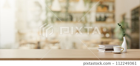 A presentation space on a wooden desk in a beautiful Scandinavian coffee shop. A presentation space on a wooden desk in a beautiful Scandinavian coffee shop. 112249361