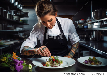portrait of beautiful female chef preparing vegetable salad in kitchen at restaurant portrait of beautiful female chef preparing vegetable salad in kitchen at restaurant 112249541