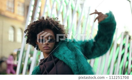 Young attractive woman with curly hair dancing rnb outdoor, stylish clothes Young attractive woman with curly hair dancing rnb outdoor, stylish clothes 112251708