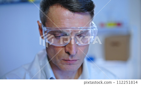 Focused male scientist checking the quality of food samples in laboratory Focused male scientist checking the quality of food samples in laboratory 112251814