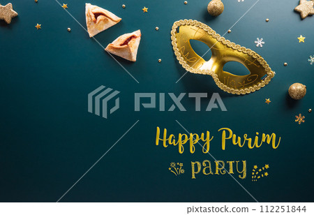Happy Purim carnival decoration concept made from golden mask star and glitter on dark background. (Happy Purim in Hebrew, jewish holiday celebrate) Happy Purim carnival decoration concept made from golden mask star and glitter on dark background. (Happy Purim in Hebrew, jewish holiday celebrate) 112251844