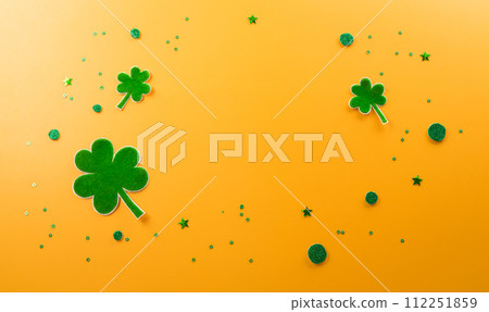Happy St Patrick's Day decoration concept made from shamrocks ( clover leaf) on yellow background. 112251859