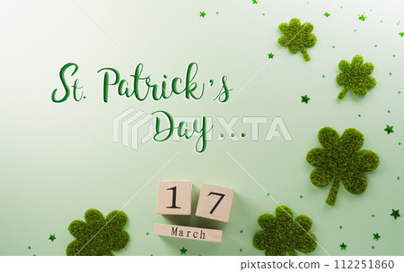 Happy St Patrick's Day decoration concept made from shamrocks ( clover leaf) and wooden calendar on green pastel background. Happy St Patrick's Day decoration concept made from shamrocks ( clover leaf) and wooden calendar on green pastel background. 112251860
