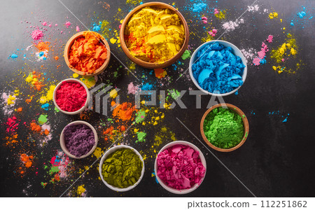Happy Holi decoration, the indian festival.Top view of colorful holi powder on dark background. Happy Holi decoration, the indian festival.Top view of colorful holi powder on dark background. 112251862
