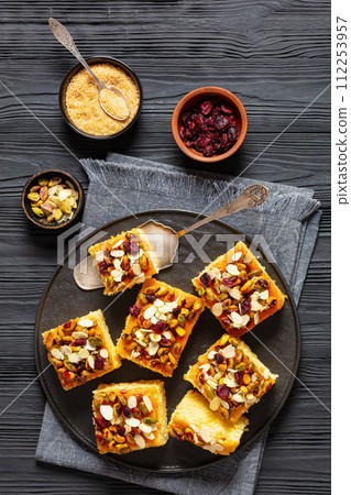 slices of yogurt cake with nuts and dried berries 112253957