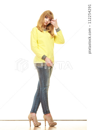blonde fashionable woman in yellow blouse 112254291