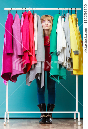 Woman choosing clothes to wear in mall or wardrobe 112254300