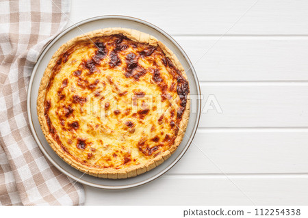 Traditional french pie. Quiche lorraine on white table. 112254338