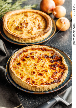 Traditional french pie. Quiche lorraine on kitchen table. 112254352