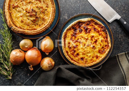 Traditional french pie. Quiche lorraine on kitchen table. Top view. Traditional french pie. Quiche lorraine on kitchen table. Top view. 112254357