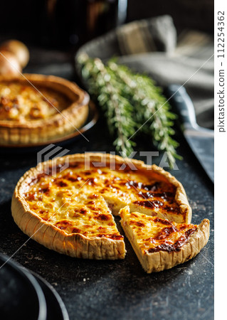Traditional french pie. Quiche lorraine on kitchen table. 112254362