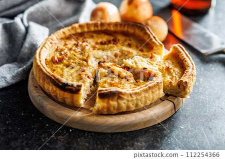 Traditional french pie. Quiche lorraine on kitchen table. 112254366