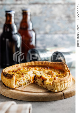 Traditional french pie. Quiche lorraine on kitchen table. 112254369