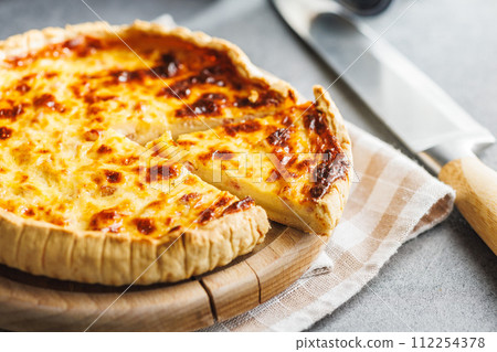 Traditional french pie. Quiche lorraine on kitchen table. 112254378
