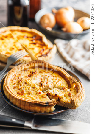 Traditional french pie. Quiche lorraine on kitchen table. 112254386