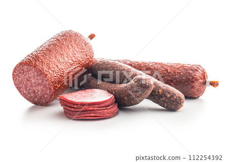 Sliced salami sausage isolated on white background. Sliced salami sausage isolated on white background. 112254392