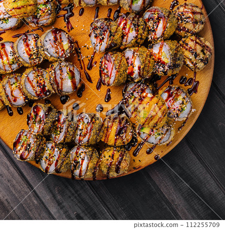 warm tempura sushi roll with seafood 112255709