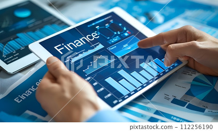 A businessman uses a tablet to view financial data. The tablet d A businessman uses a tablet to view financial data. The tablet d 112256190