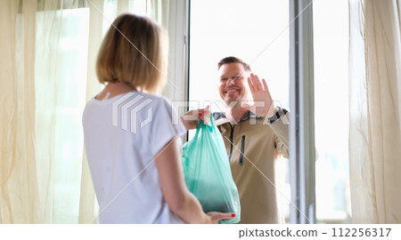 Male courier brought a package with groceries and delivery of goods 112256317