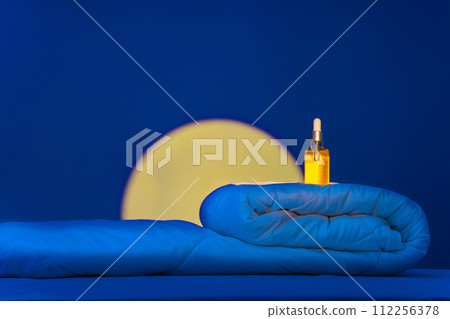 Cosmetic serum, essence on blanket in bedroom in moonlight. Night skin care concept, beauty and health in sleep. Moisturizing, restoring skin functions, youth while you sleep Cosmetic serum, essence on blanket in bedroom in moonlight. Night skin care concept, beauty and health in sleep. Moisturizing, restoring skin functions, youth while you sleep 112256378