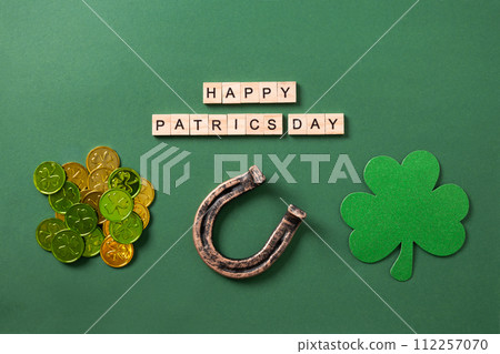 St. Patrick's day composition with clover leaf, horseshoe on green. 112257070