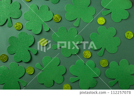 St. Patrick's day banner with clover leaves and green coins on green . St. Patrick's day banner with clover leaves and green coins on green . 112257078