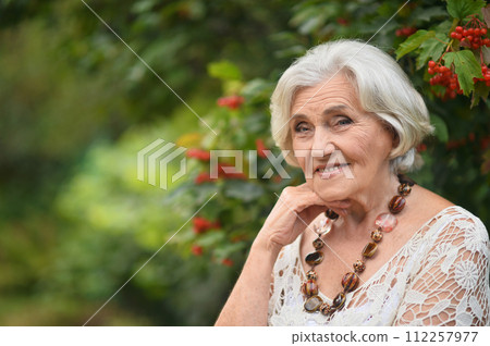 Portrait of happy senior woman posing at forest Portrait of happy senior woman posing at forest 112257977