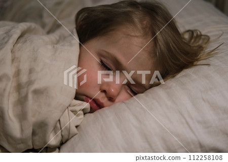 Child Falls Asleep. Peaceful Adorable Baby Sleeping at Home. Slumbering Little Toddler. Two Years Old Girl Sleeps. Nursery Room Interior Background. Serene Dream. Cute Face Close Up. Deep Kid Slumber Child Falls Asleep. Peaceful Adorable Baby Sleeping at Home. Slumbering Little Toddler. Two Years Old Girl Sleeps. Nursery Room Interior Background. Serene Dream. Cute Face Close Up. Deep Kid Slumber 112258108